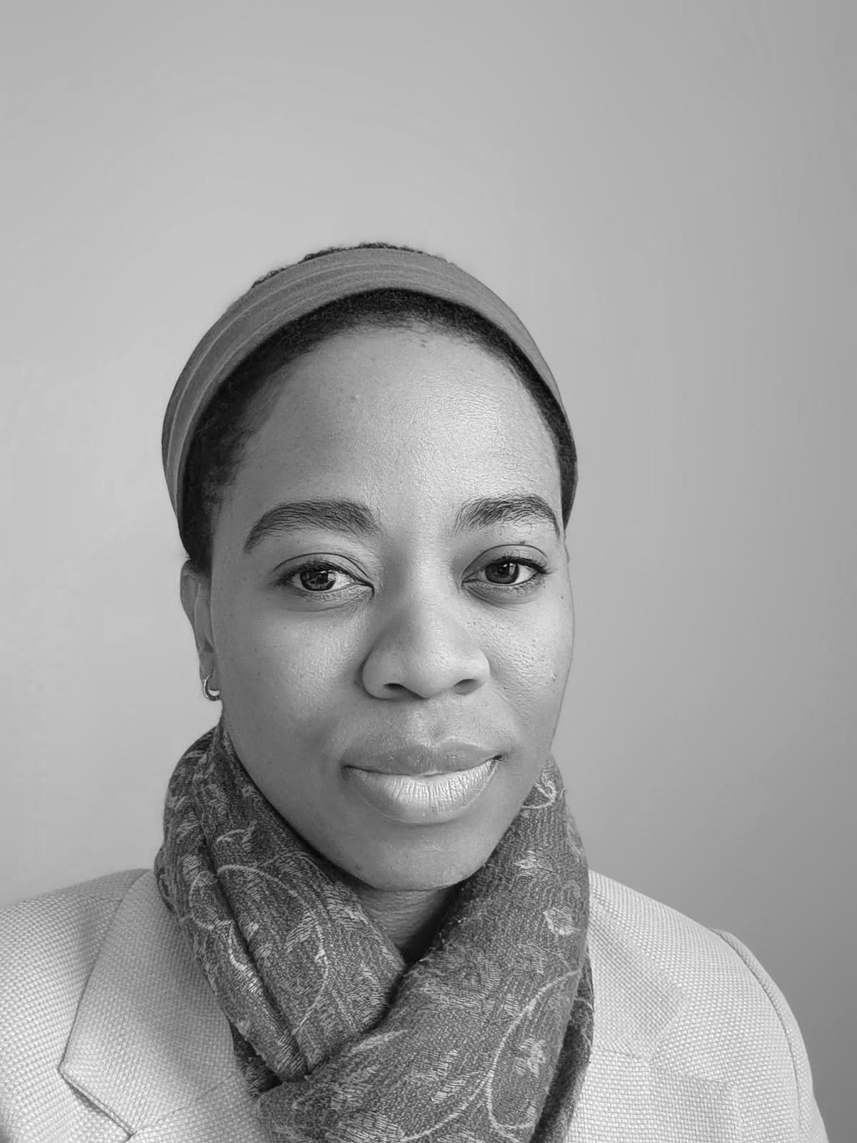 Close-up portrait of a young woman wearing a headband and scarf