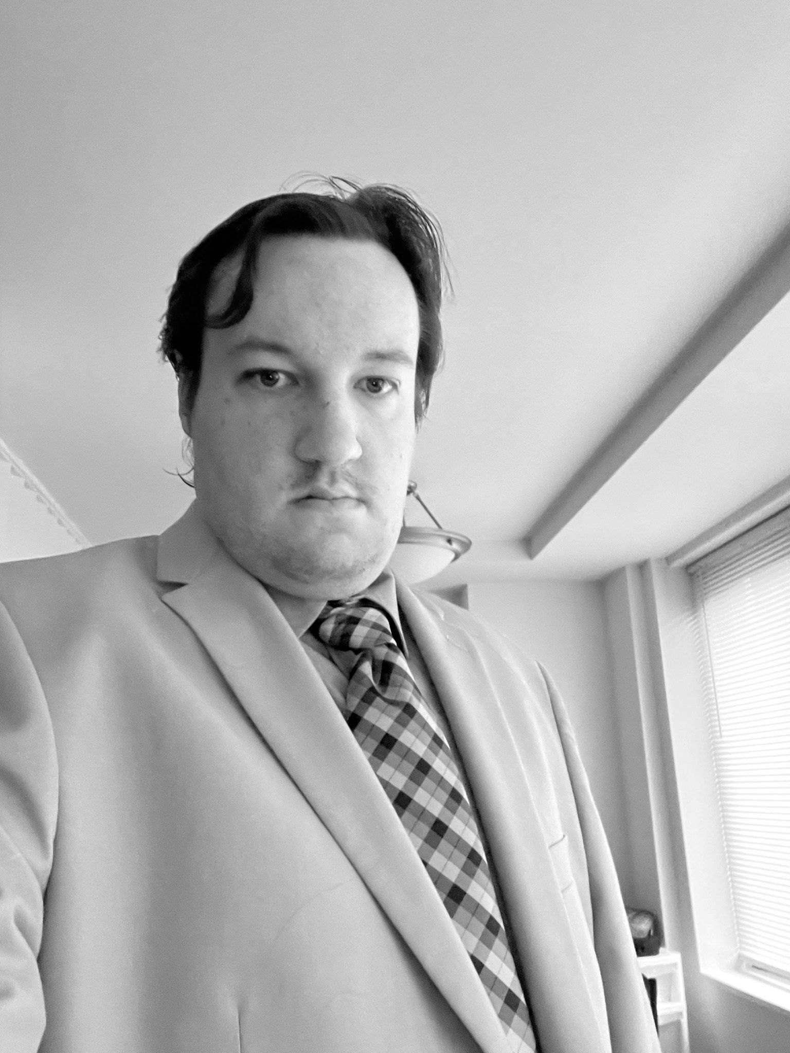 Portrait from a low angle of a young man wearing a tie and blazer